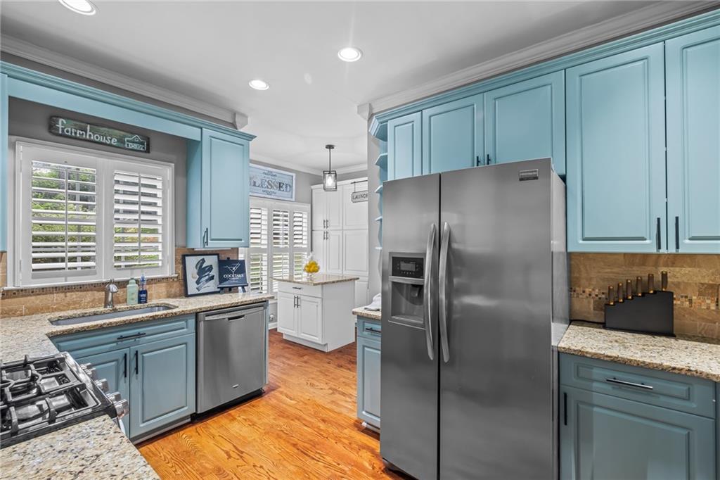 555 Douthit Ferry Road Cartersville, GA 30120 - Photo 16 of 36 a kitchen with stainless steel appliances granite countertop a refrigerator a sink a stove and island