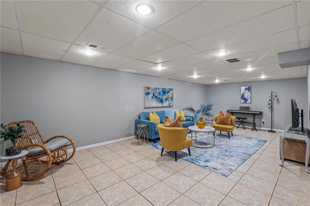 555 Douthit Ferry Road Cartersville, GA 30120 - Photo 29 of 36 a living room with lots of furniture and a potted plant