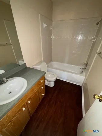 a bathroom with a double vanity sink toilet and shower