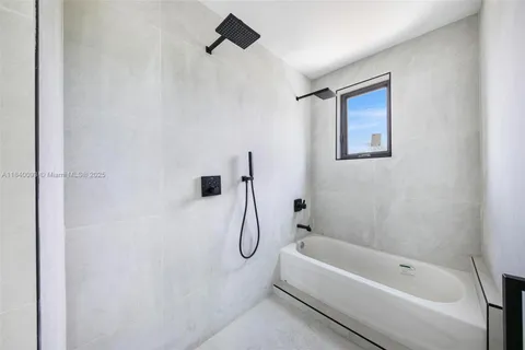 a bathroom with a bathtub and a shower