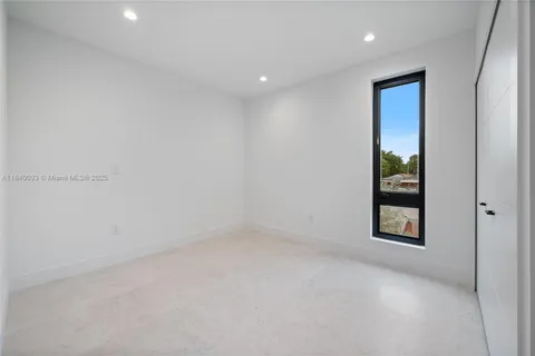 an empty room with windows and closet