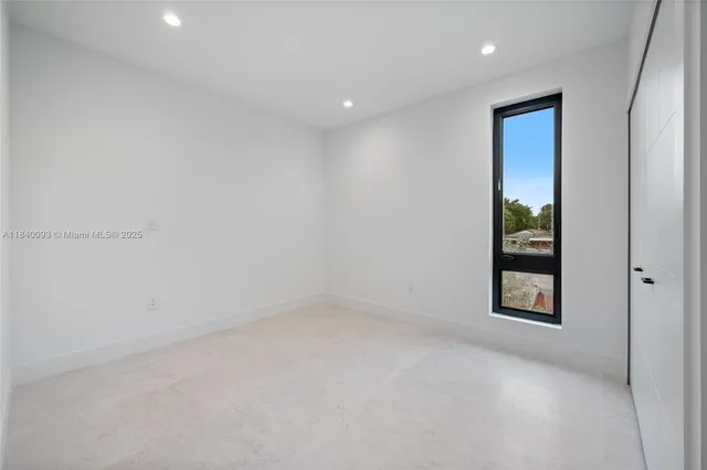 an empty room with windows and closet