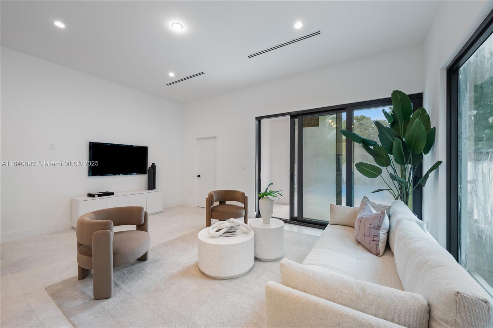 2937 Southwest 21st Street Miami, FL 33145 - Photo 5 of 30 a living room with furniture and a flat screen tv