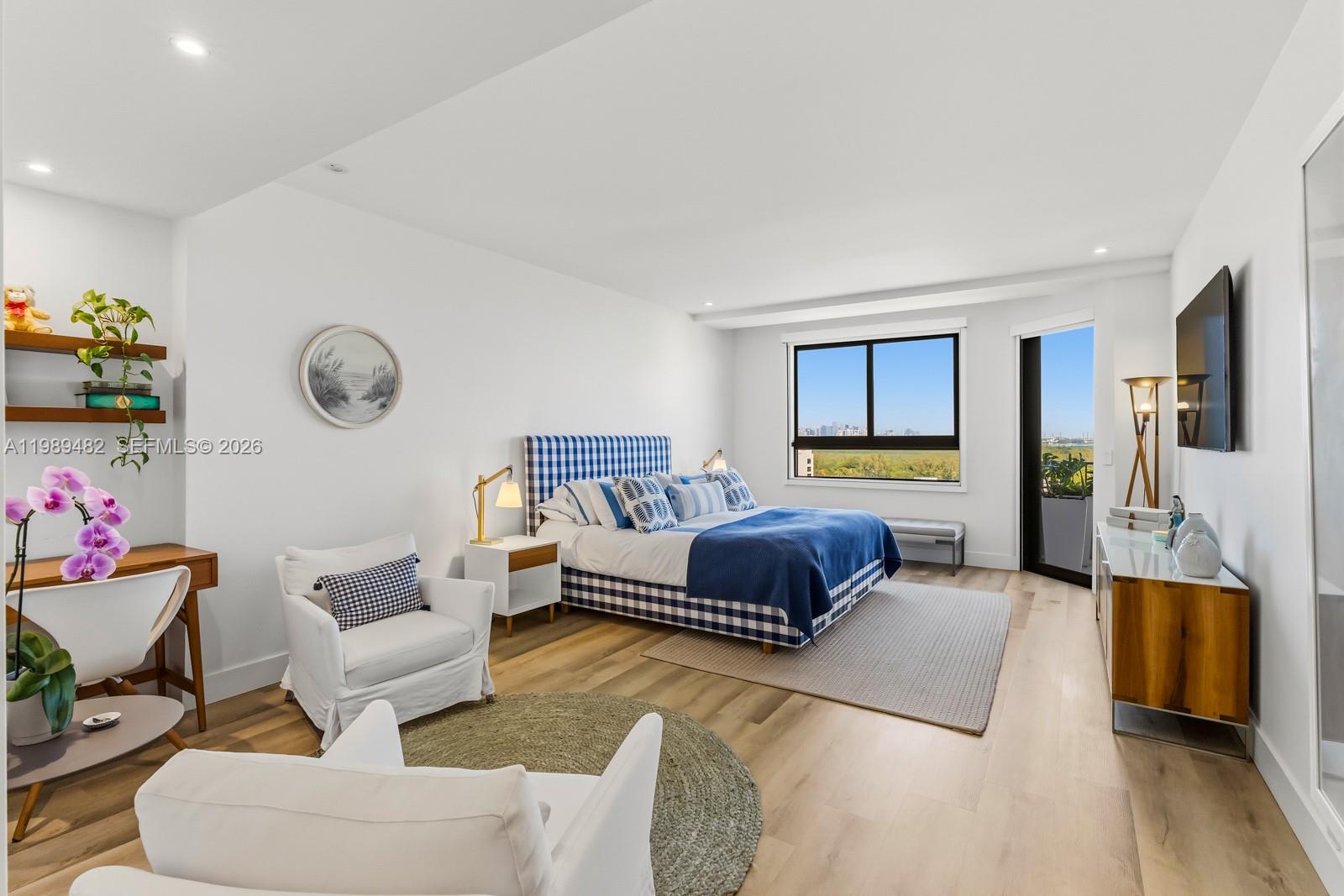 151 Crandon Boulevard, Unit 1222 Key Biscayne, FL 33149 - Photo 12 of 31 a spacious bedroom with a bed window and couch