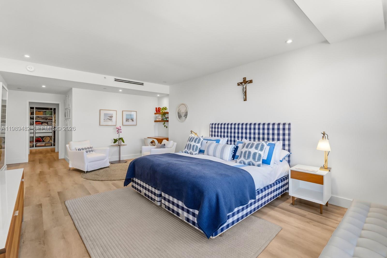 151 Crandon Boulevard, Unit 1222 Key Biscayne, FL 33149 - Photo 13 of 31 a spacious bedroom with a bed and a couch