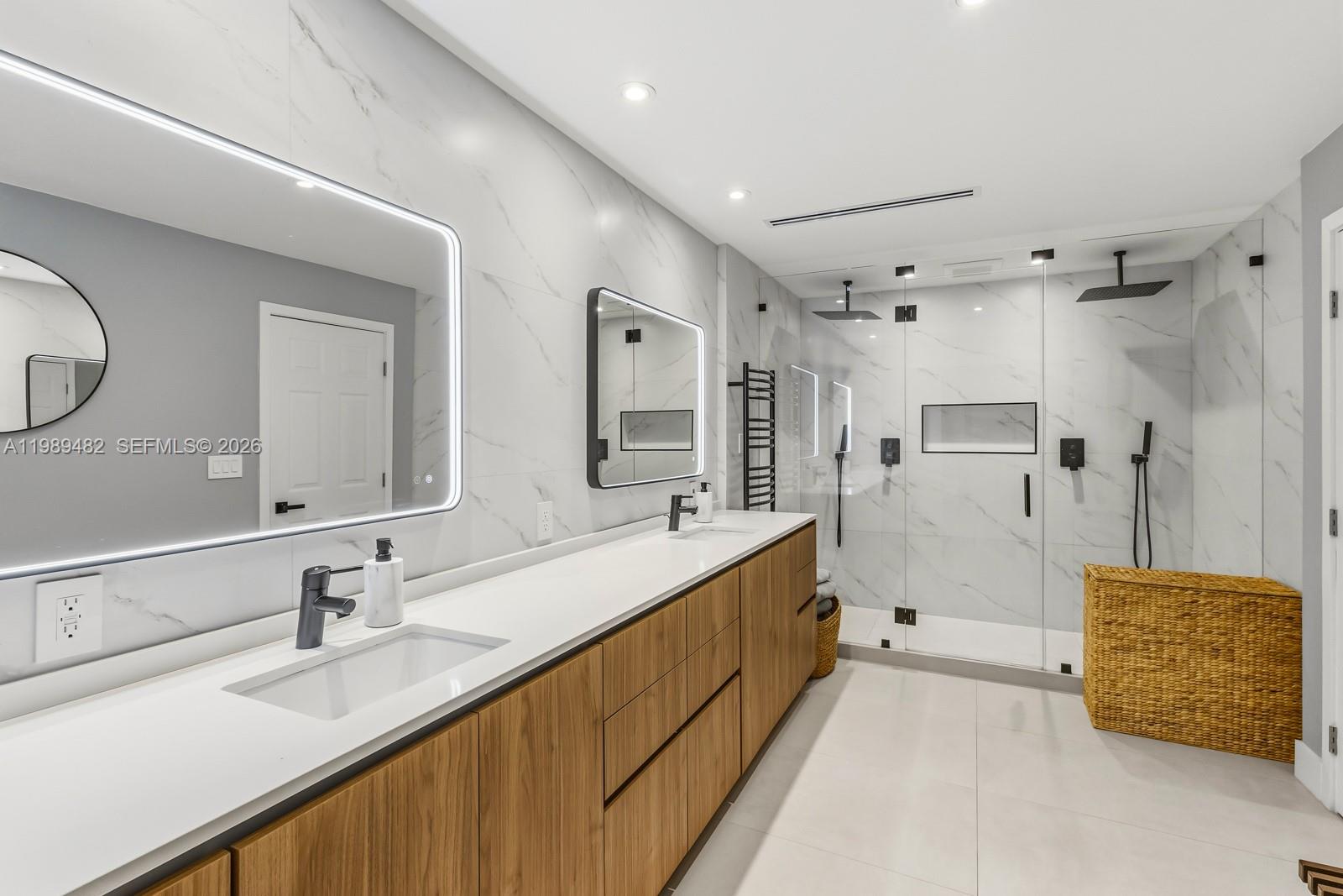 151 Crandon Boulevard, Unit 1222 Key Biscayne, FL 33149 - Photo 14 of 31 a spacious bathroom with a double vanity sink mirror and shower