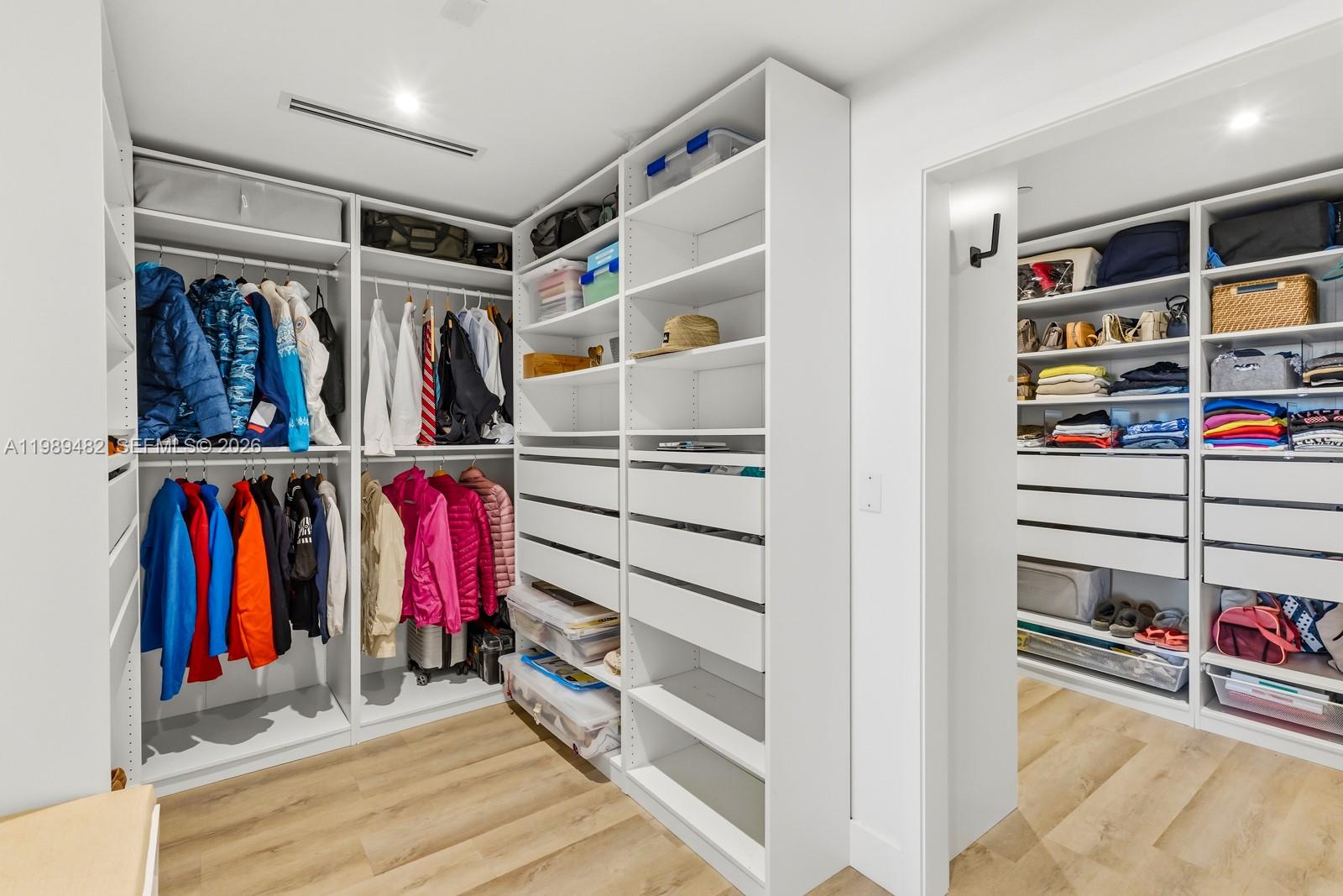 151 Crandon Boulevard, Unit 1222 Key Biscayne, FL 33149 - Photo 16 of 31 a view of walk in closet with clothes and shoes