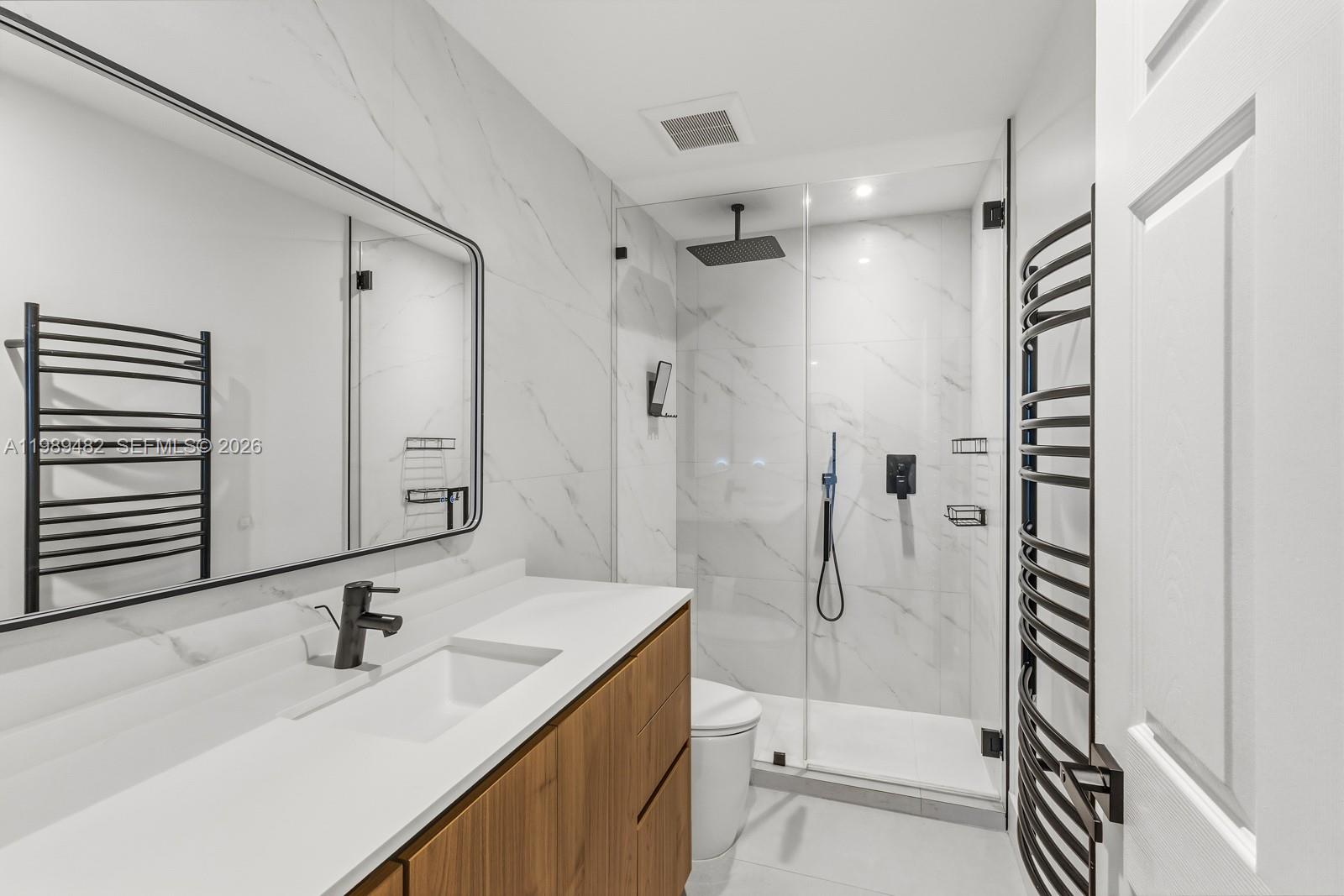 151 Crandon Boulevard, Unit 1222 Key Biscayne, FL 33149 - Photo 18 of 31 a bathroom with a sink a toilet and shower