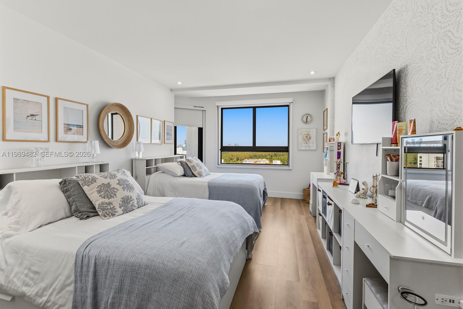 151 Crandon Boulevard, Unit 1222 Key Biscayne, FL 33149 - Photo 19 of 31 a bedroom with bed and a large mirror