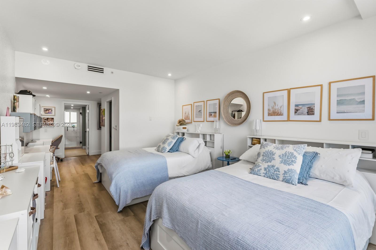 151 Crandon Boulevard, Unit 1222 Key Biscayne, FL 33149 - Photo 20 of 31 a bedroom with two beds and a large mirror