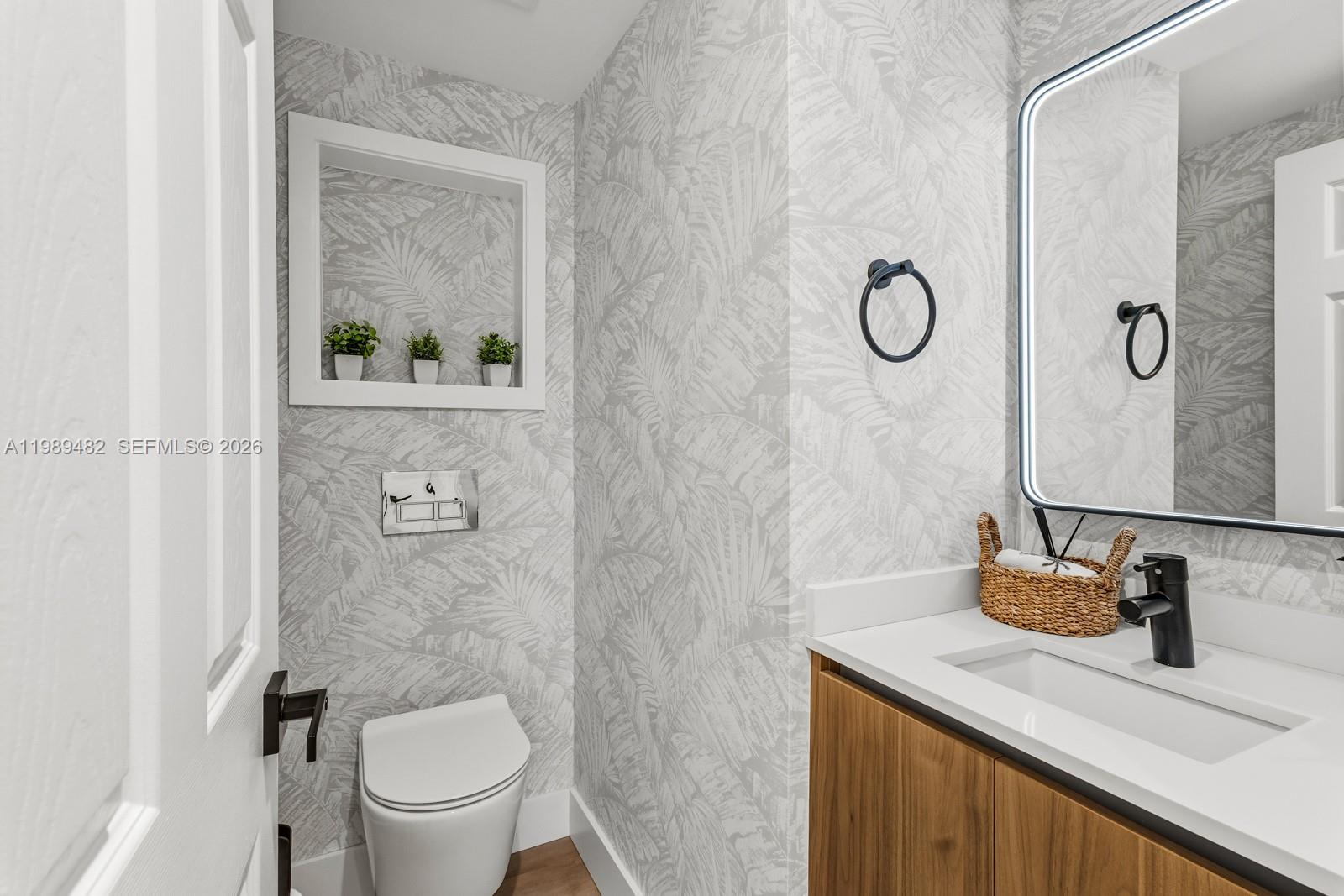 151 Crandon Boulevard, Unit 1222 Key Biscayne, FL 33149 - Photo 25 of 31 a bathroom with a granite countertop sink a toilet and a mirror