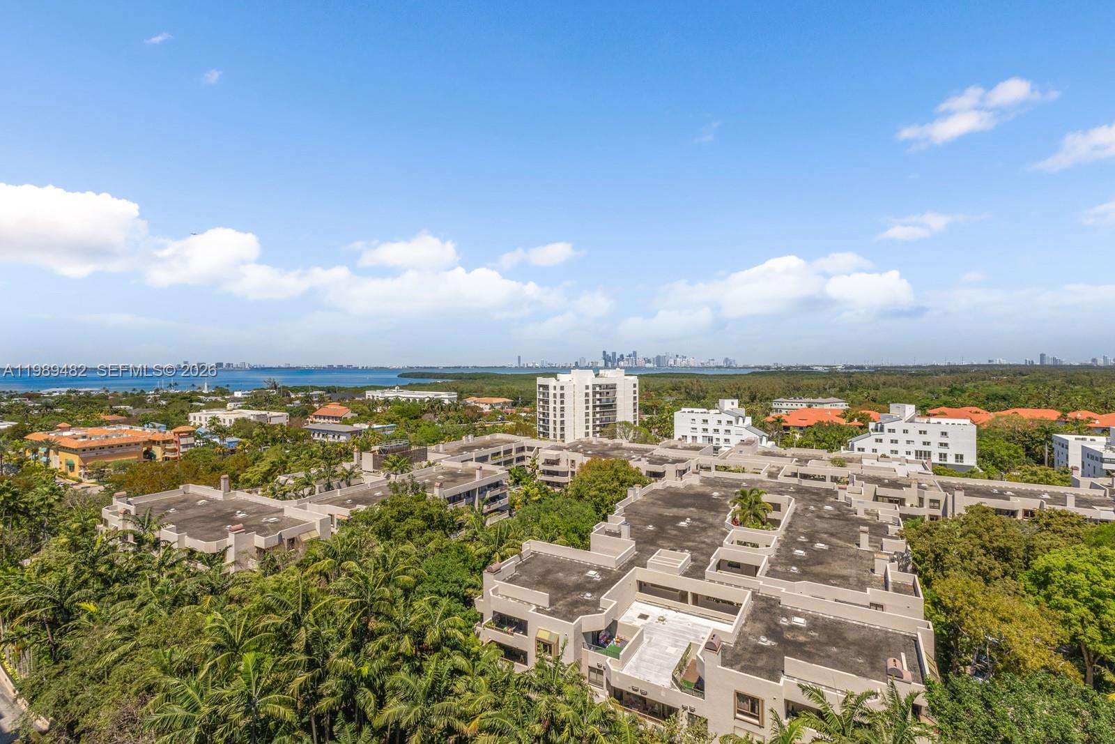 151 Crandon Boulevard, Unit 1222 Key Biscayne, FL 33149 - Photo 27 of 31 a view of a city with lots of residential buildings ocean and mountain in the back