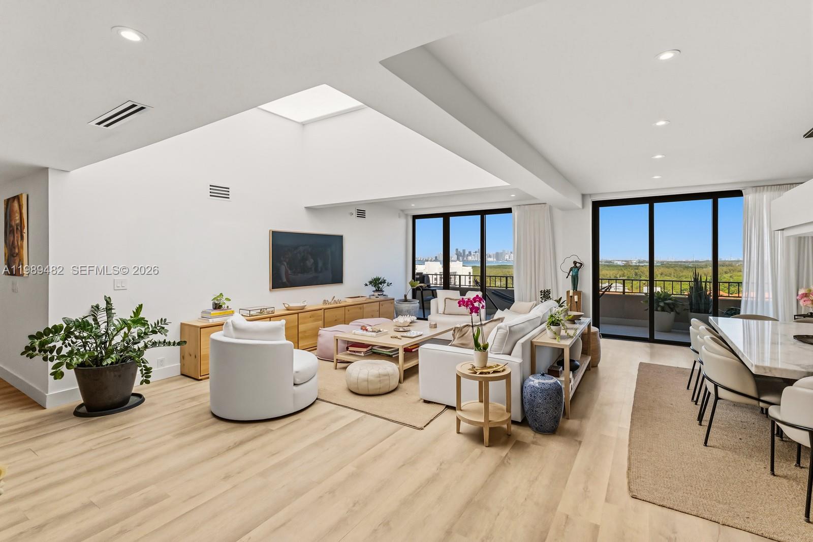 151 Crandon Boulevard, Unit 1222 Key Biscayne, FL 33149 - Photo 6 of 31 a living room with furniture potted plant and a flat screen tv