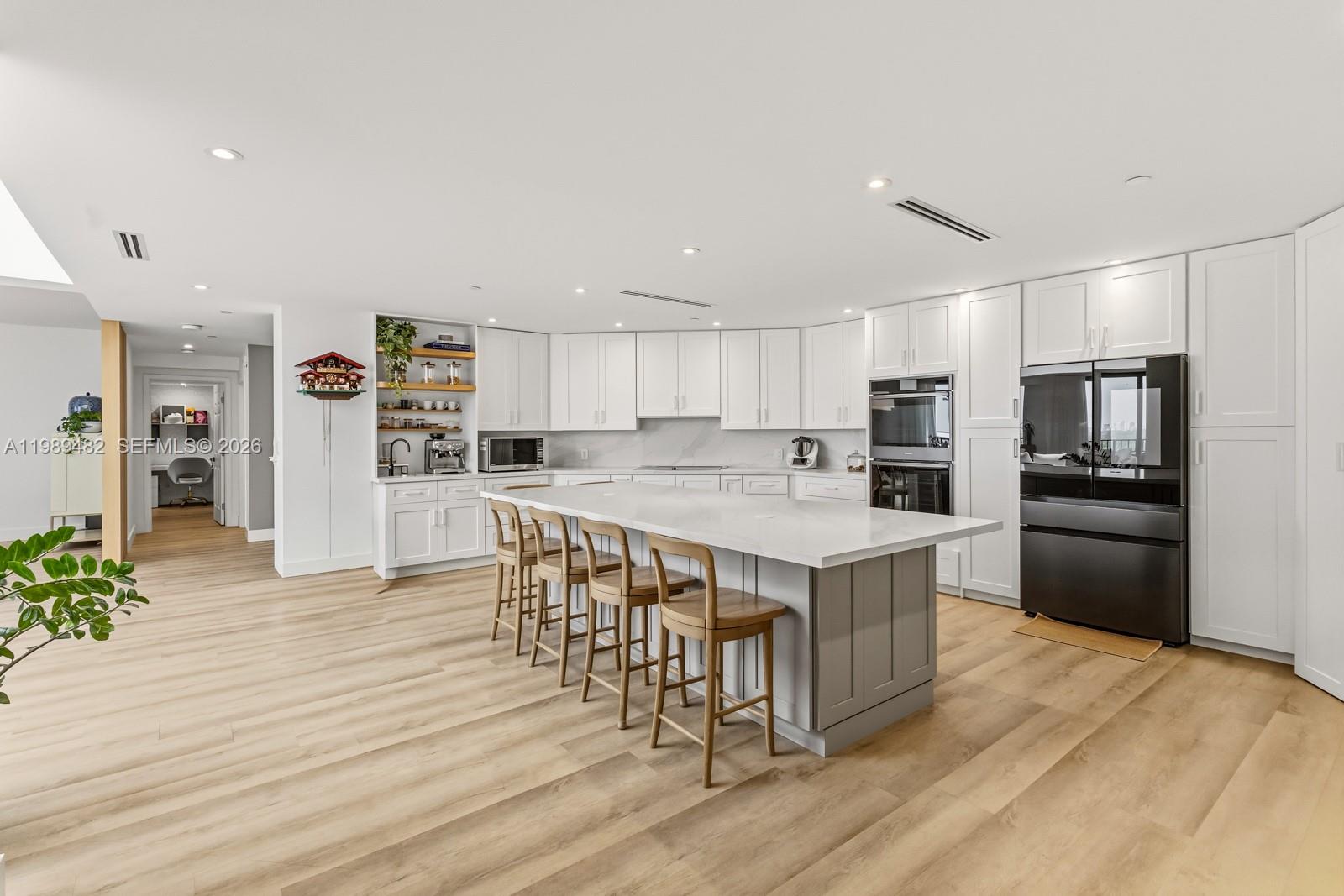 151 Crandon Boulevard, Unit 1222 Key Biscayne, FL 33149 - Photo 9 of 31 a kitchen with stainless steel appliances a refrigerator a stove a sink dishwasher and a refrigerator with wooden floor