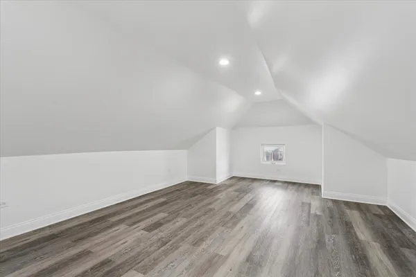 a view of an empty room and wooden floor