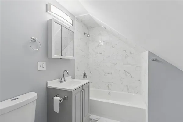 a bathroom with a sink a toilet and bathtub