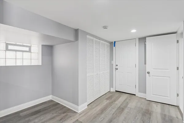 a view of an empty room with wooden floor