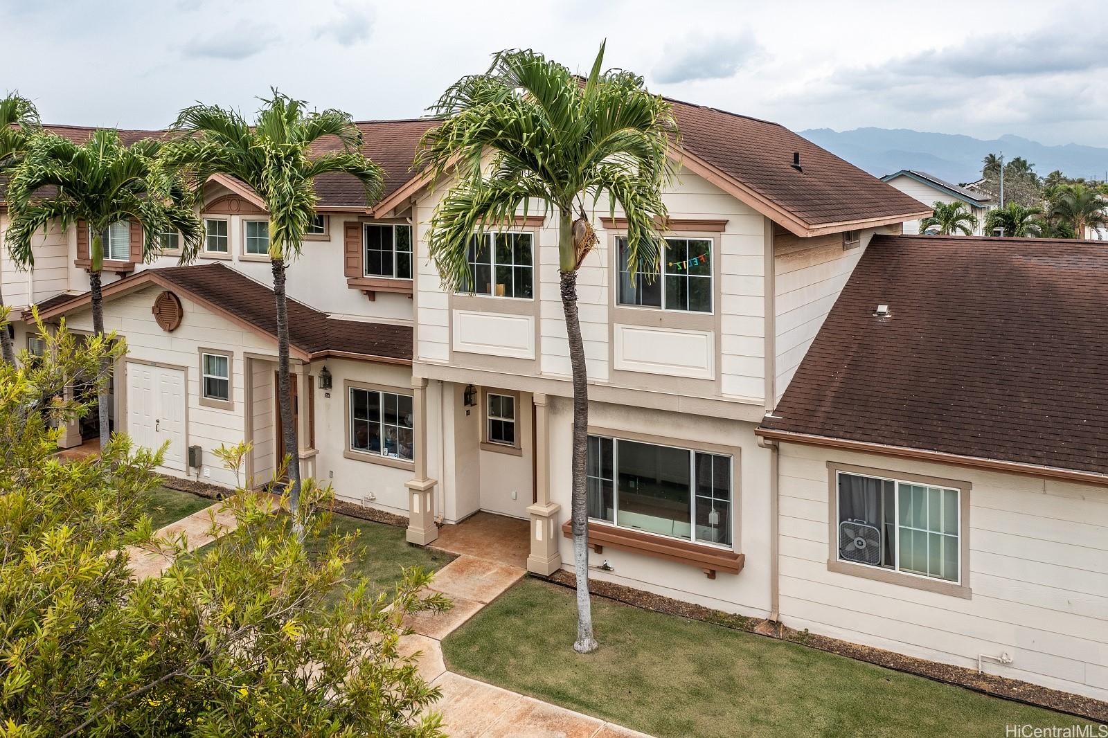 91-1010 Kaimalie Street, Unit S5 Ewa Beach, HI 96706 - Photo 1 of 1 a front view of a house with a yard