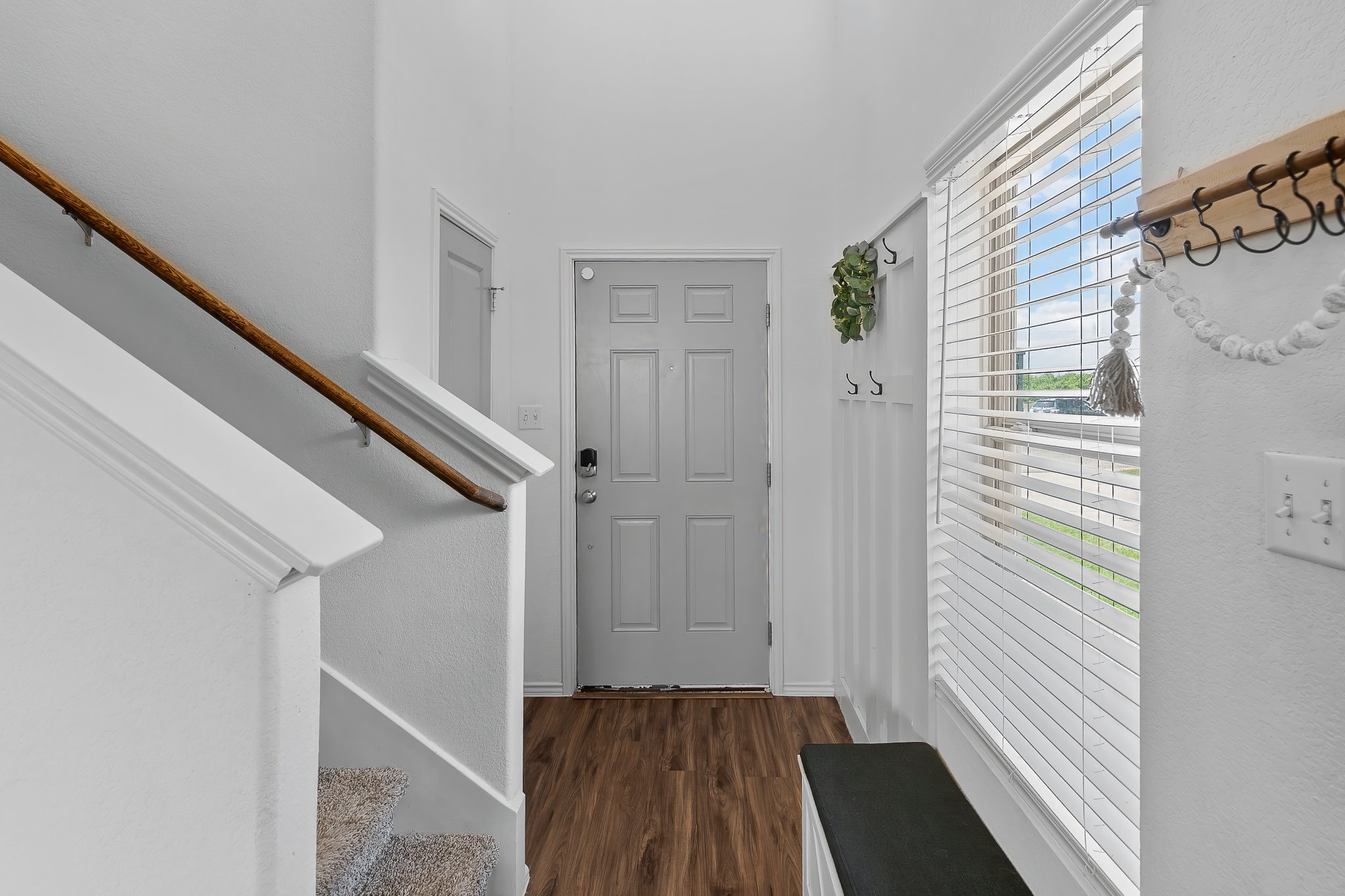 576 Greatest Gift Way Jarrell, TX 76537 - Photo 4 of 37 A welcoming entry features durable laminate flooring and a staircase leading to additional levels.