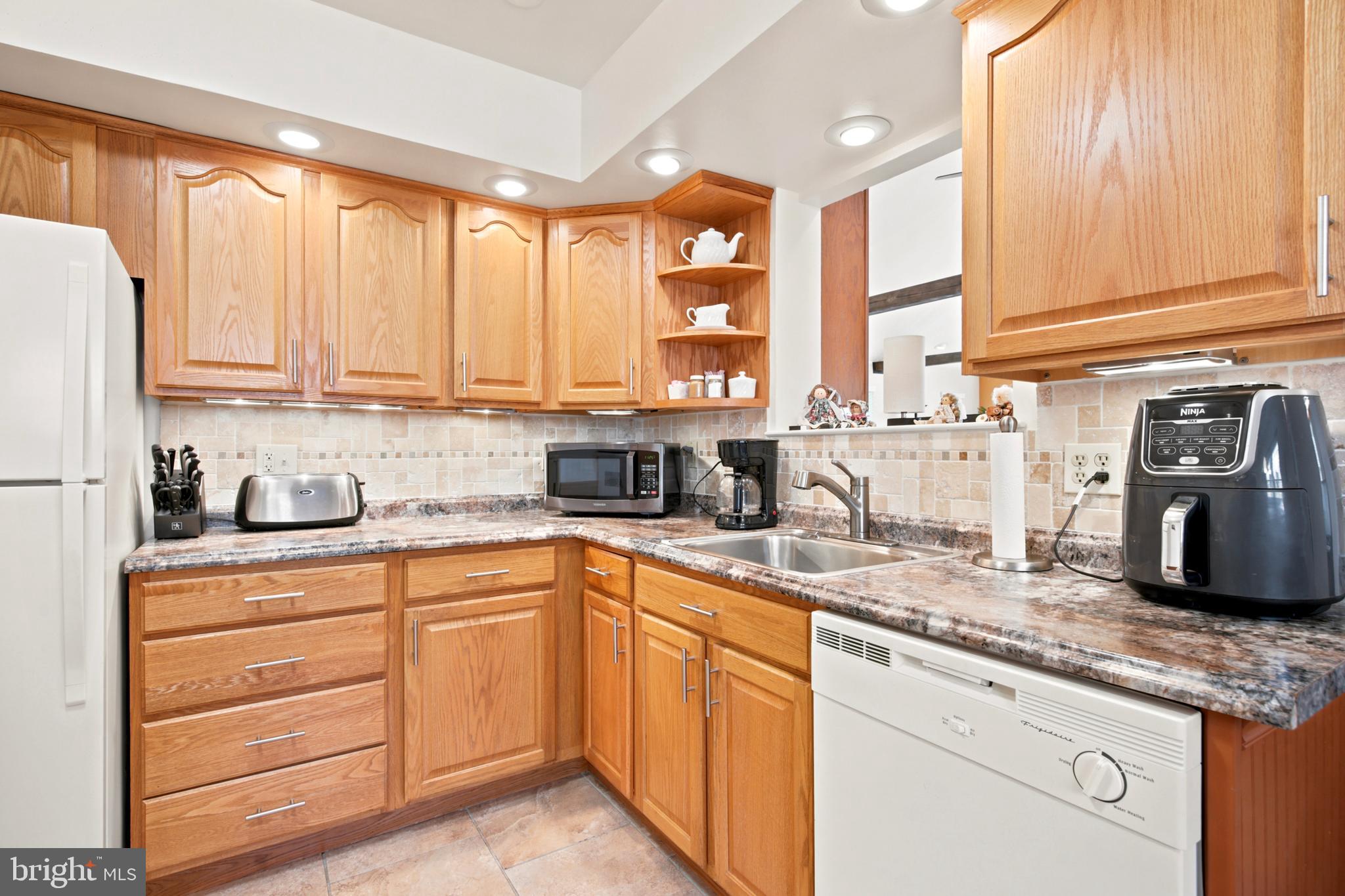 1004 Green Lane Secane, PA 19018 - Photo 13 of 49 a kitchen with stainless steel appliances granite countertop a sink a stove and cabinets