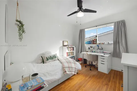 a bedroom with a bed and a desk