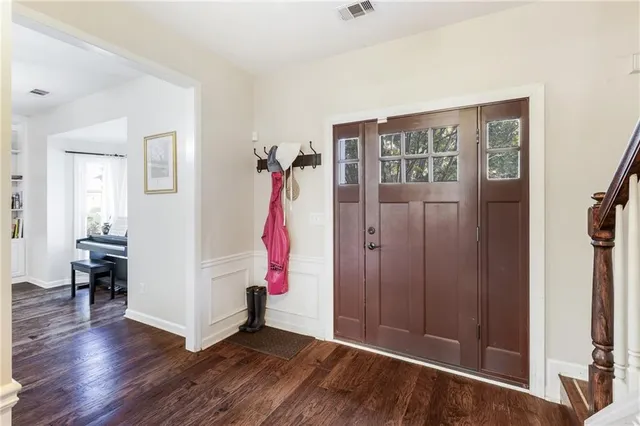 a kitchen with stainless steel appliances kitchen island granite countertop a refrigerator and a stove top oven
