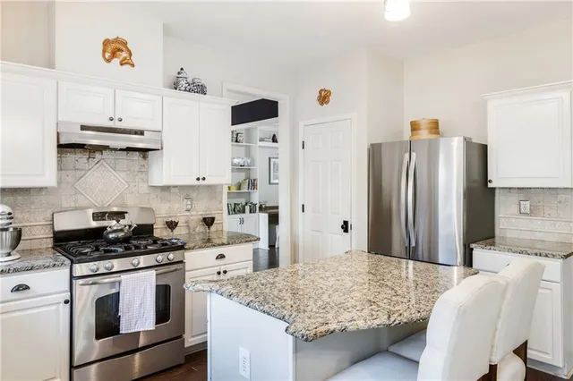 a living room with furniture wooden floor and a chandelier