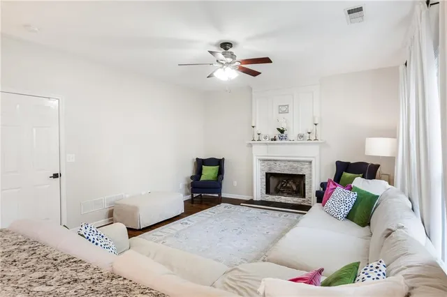 a living room with furniture or chandelier and a large window