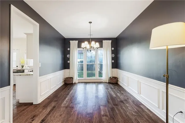 a living room with furniture and a book shelf