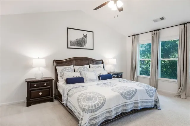 a kitchen with stainless steel appliances a stove a refrigerator and a wooden floor