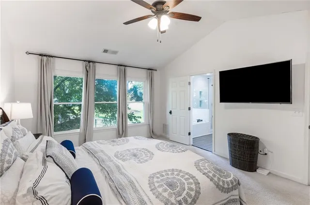 a large white kitchen with stainless steel appliances granite countertop a sink and cabinets