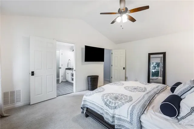 a en suite bathroom with a double vanity sink and a window