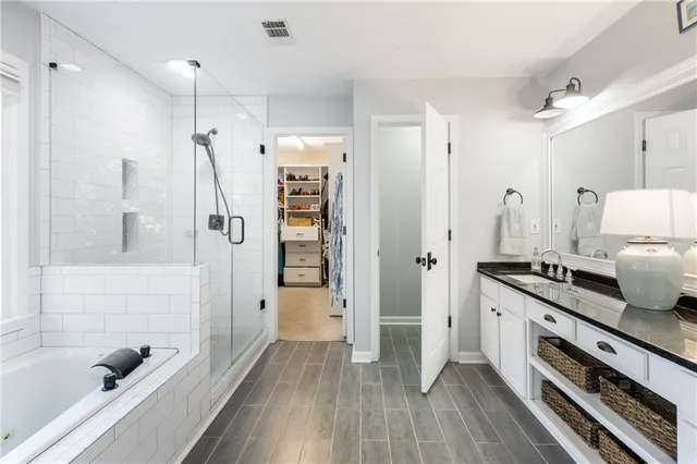 a bathroom with a tub and shower