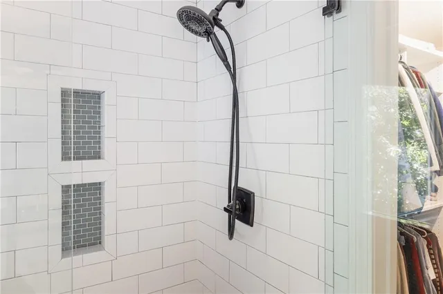 a view of a room with a ceiling fan and a large window
