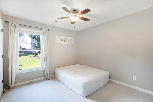 a view of a workspace with furniture and a chandelier fan