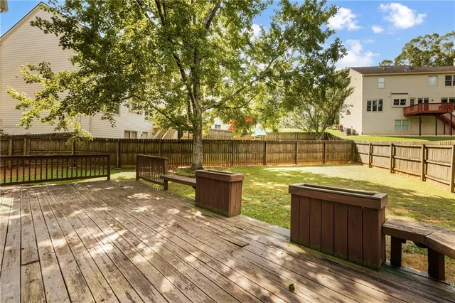 a house view with swimming pool in front of it