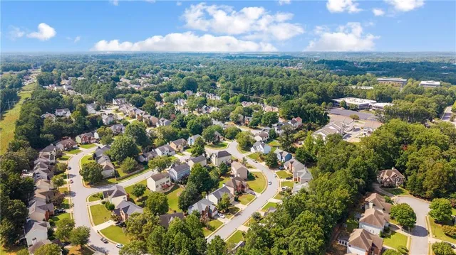 an aerial view of a house with swimming pool and garden space