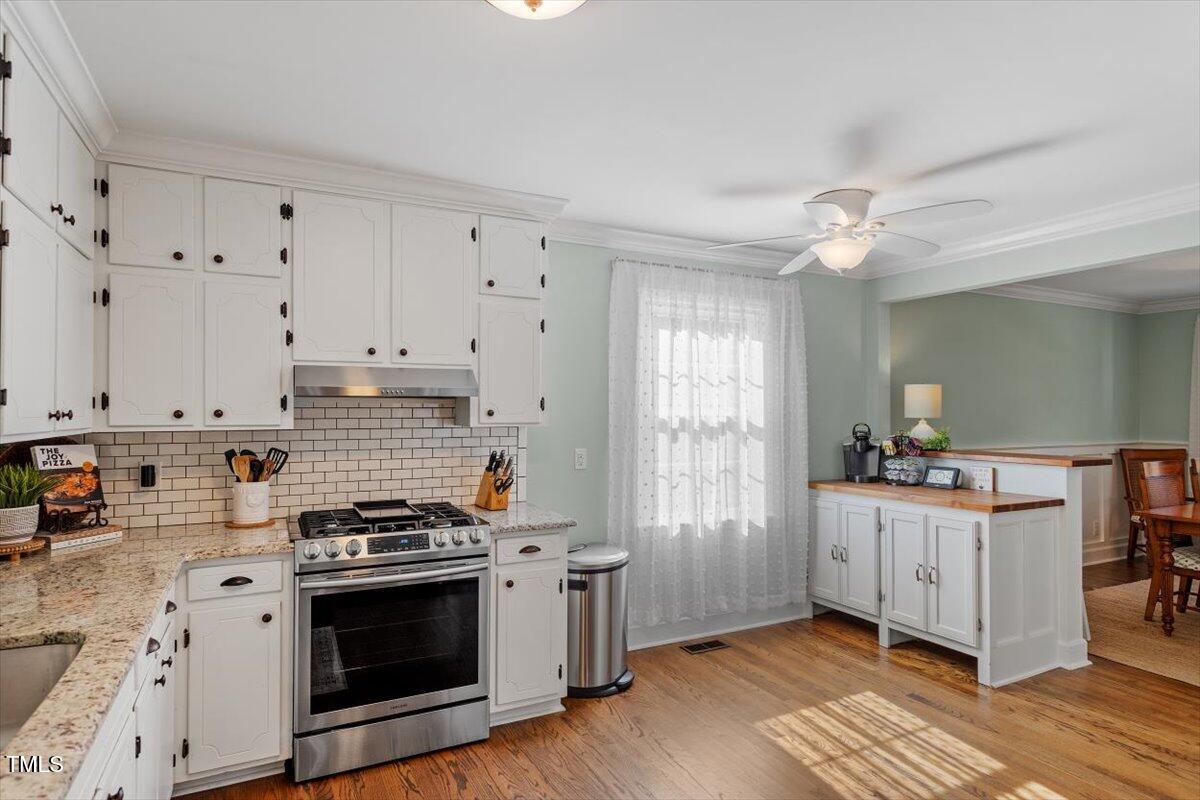 134 Landsbury Drive Durham, NC 27707 - Photo 18 of 44 a kitchen with stainless steel appliances a white stove top oven and a refrigerator