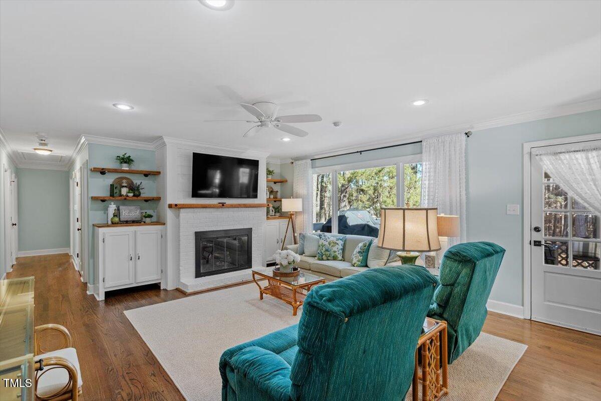 134 Landsbury Drive Durham, NC 27707 - Photo 23 of 44 a living room with furniture a fireplace and a flat screen tv