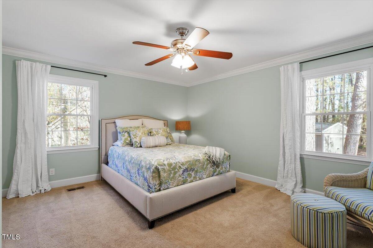134 Landsbury Drive Durham, NC 27707 - Photo 33 of 44 a spacious bedroom with a bed and window