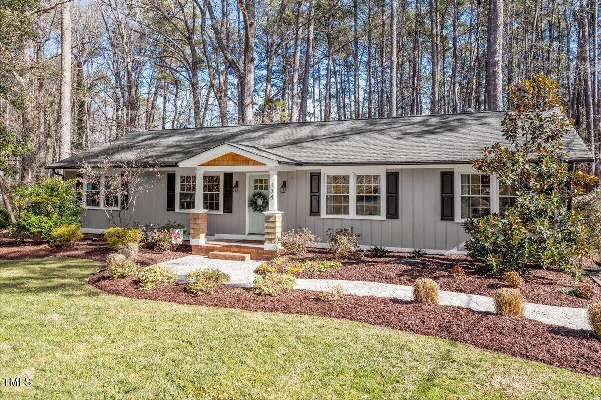 134 Landsbury Drive Durham, NC 27707 - Photo 4 of 44 a front view of house with yard outdoor seating and barbeque oven