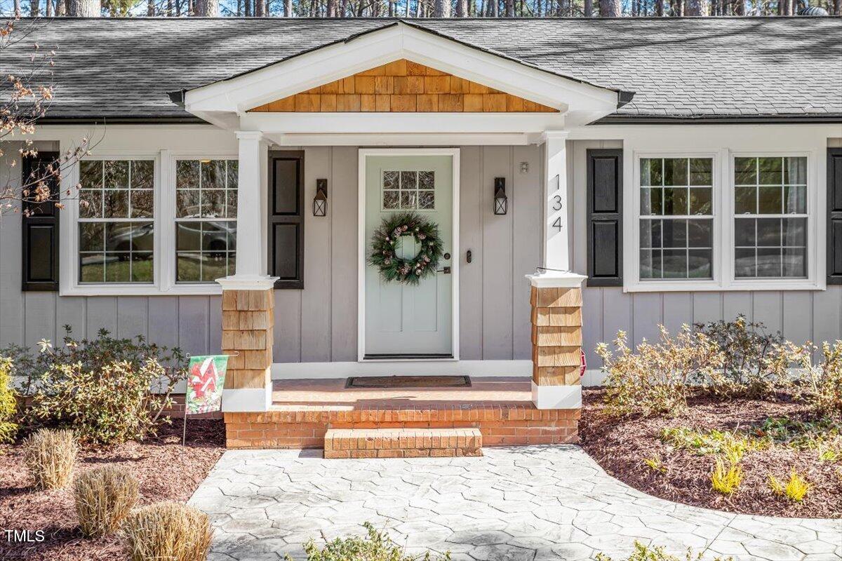 134 Landsbury Drive Durham, NC 27707 - Photo 6 of 44 a view of a brick house with potted plants