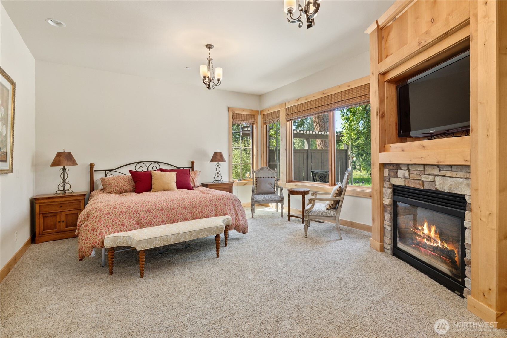 1531 Larkspur Loop Cle Elum, WA 98922 - Photo 15 of 36 a bedroom with a bed a fireplace and a large window