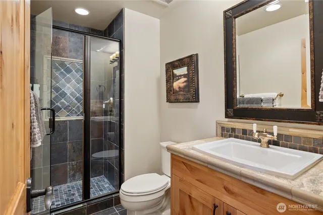 a bathroom with a sink toilet and shower
