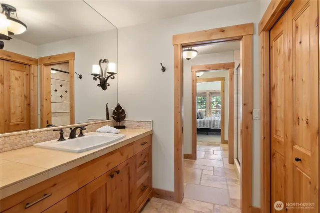 a en suite bathroom with a sink double vanity and a mirror