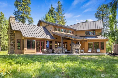 a view of a house with a yard patio and fire pit