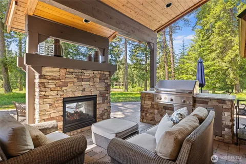 a living room with furniture a large window and a fireplace