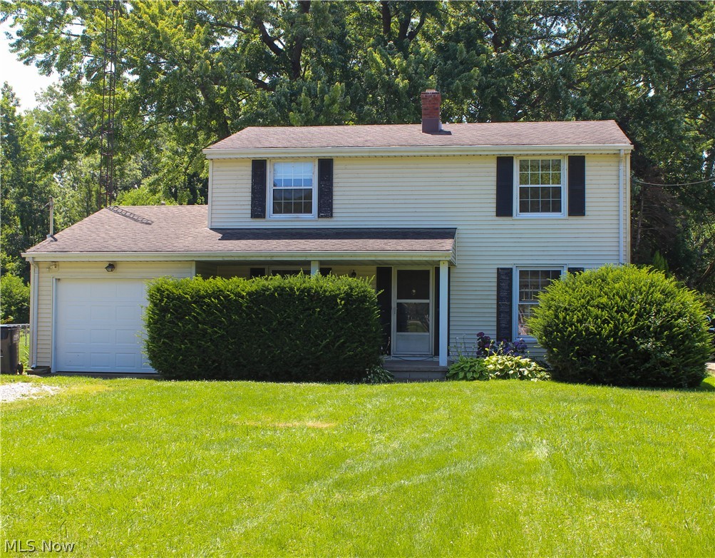 11910 West Lake Road Vermilion, OH 44089 - Photo 1 of 28 View of front of property with a garage and a front lawn