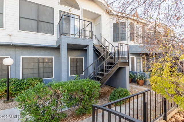 a view of a house with brick walls and wooden stairs