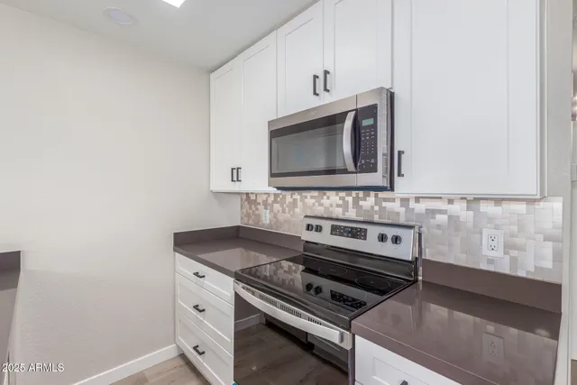 a kitchen with a stove microwave and sink